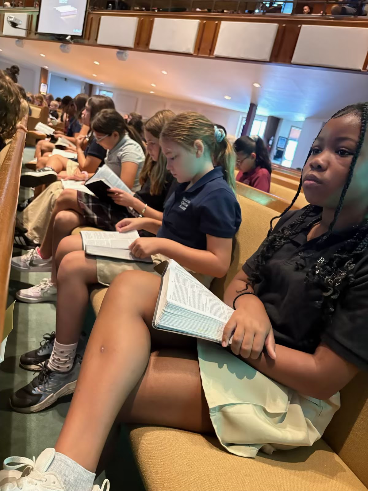 BCA secondary students following along in chapel