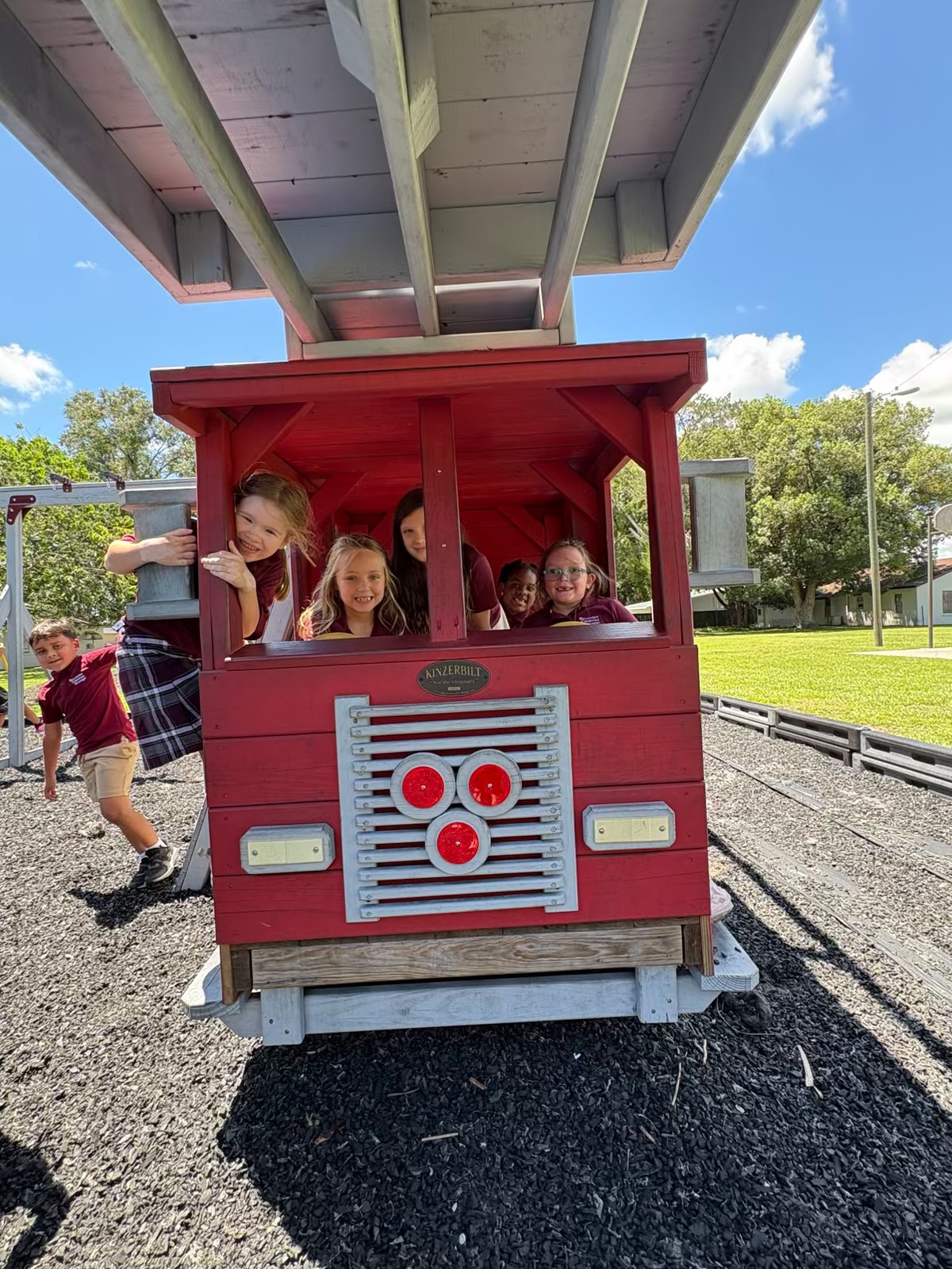 Preschool students on the playground train